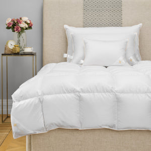 Hungarian goose down pillows and comforter on bed