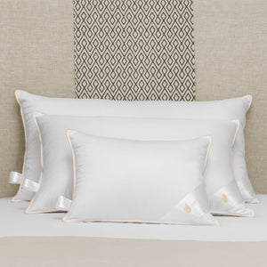 stack of 3 Hungarian goose down pillows on bed, various sizes, white