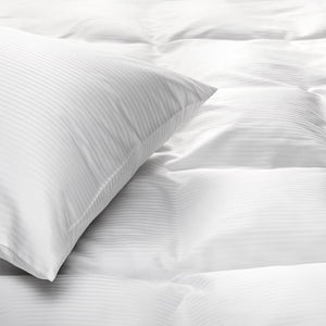 White down Pillow on white down comforter